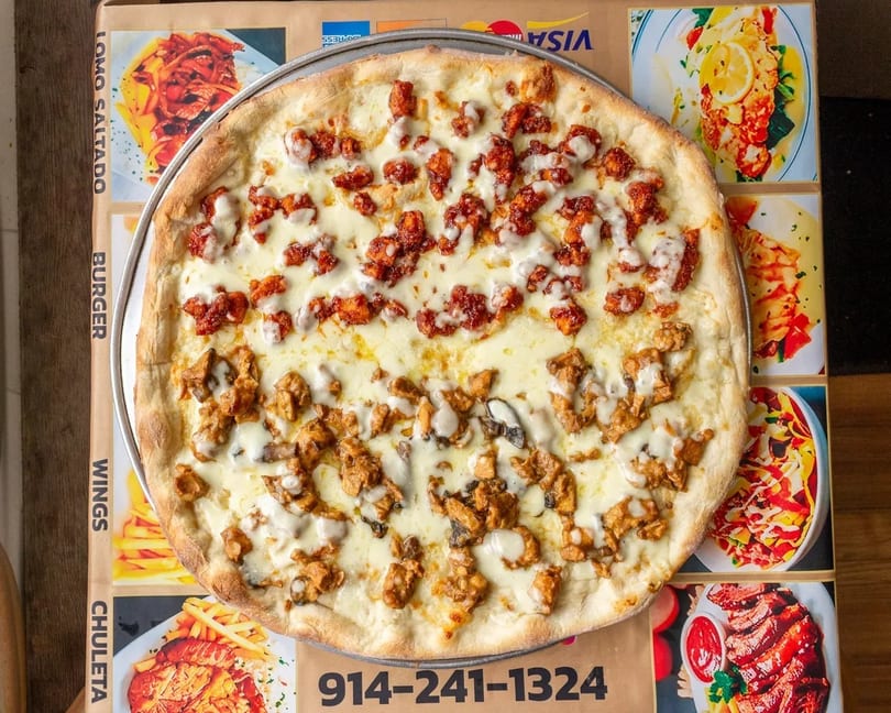 A large pizza with two different toppings, one spicy red and one savory brown, on a menu background.