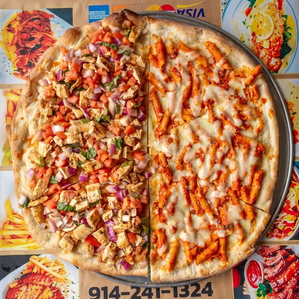 A large pizza with two different toppings: chicken bruschetta and penne pasta with cheese.
