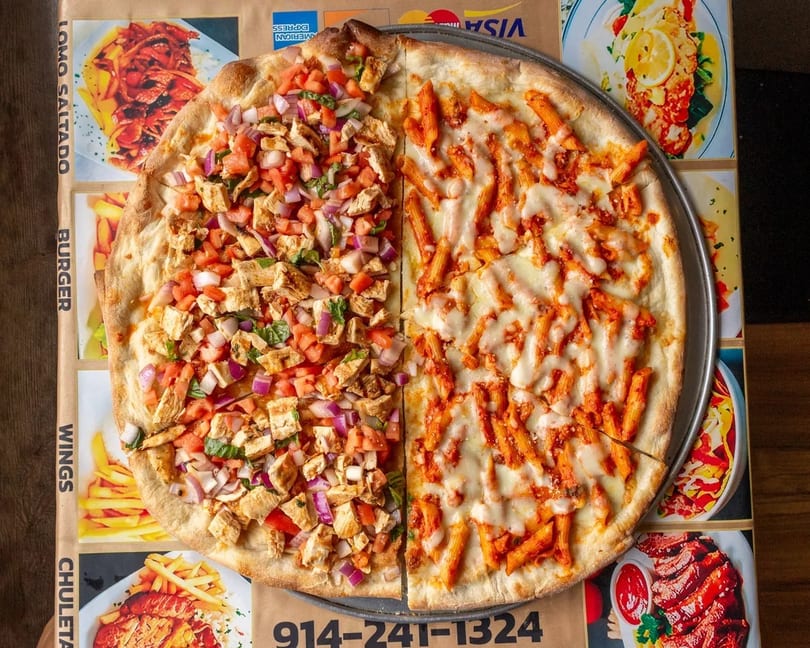 A large pizza with two different toppings: chicken bruschetta and penne pasta with cheese.