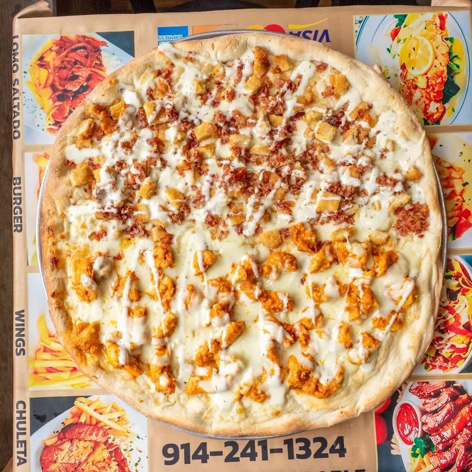 Half buffalo chicken, half bacon chicken pizza with white sauce on a menu background.